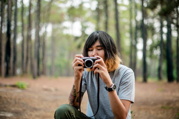 istock Asian Photographer Taking Pictures Outdoors Concept 800323810