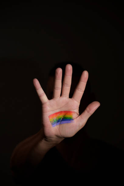 istock man with a rainbow flag in his hand 800324474