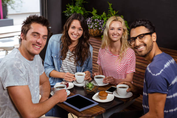 istock Smiling friends enjoying coffee together 800327226