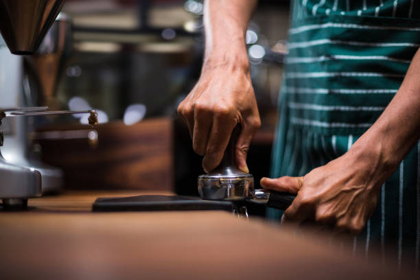 istock Waiter squeezing the coffee in the percolator 800327842