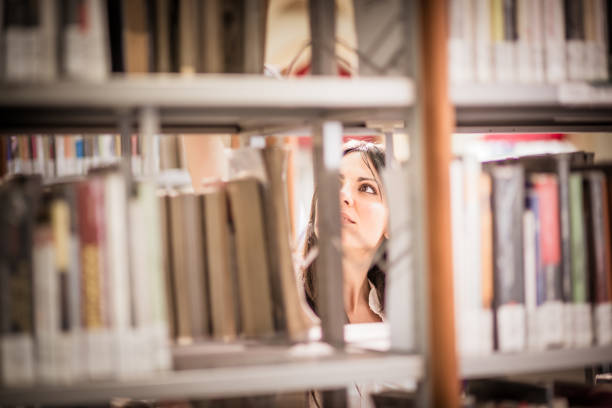 Two young women searching for books