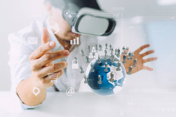 istock businessman wearing virtual reality goggles in modern office with mobile phone using with VR headset with all technology world network diagram element by NASA 800337290