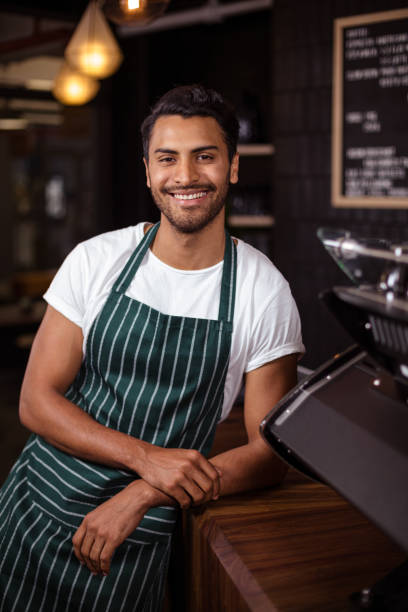 istock Smiling barista leaning against counter 800345040