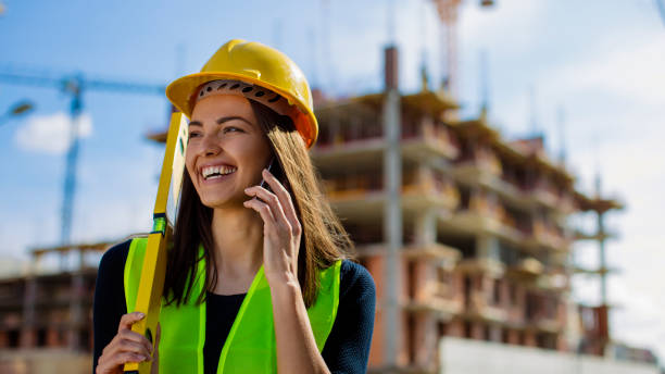 istock Smiling female at construcion site 800352320