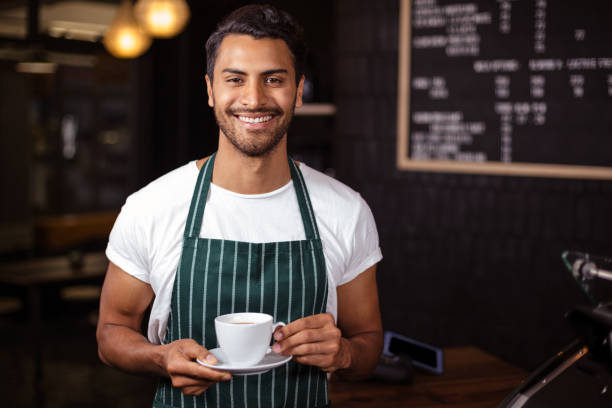 istock Smiling barista holding coffee 800355340