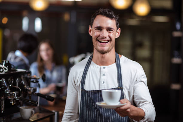 istock Smiling barista holding cappuccino 800358196