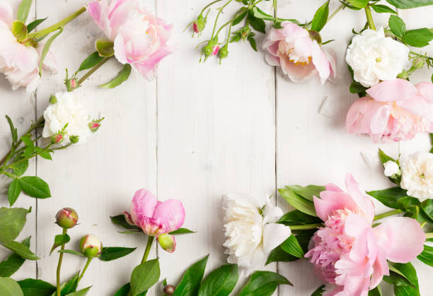 istock Pink and white flowers on wooden table. 800358694