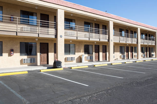 Empty Space in a Parking Lot Empty Space in a Parking Lot infront of motel room motel stock pictures, royalty-free photos & images
