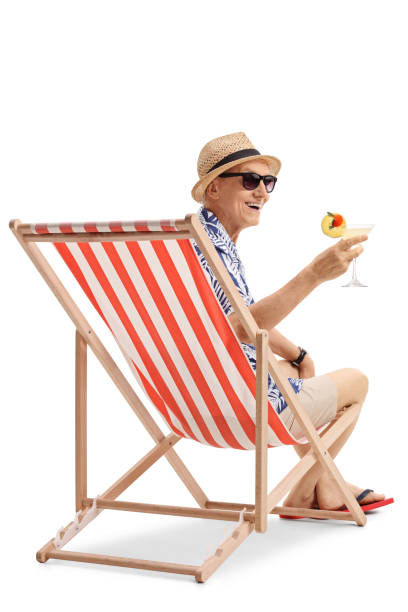 istock Happy elderly tourist with a cocktail sitting in a deck chair 800361502