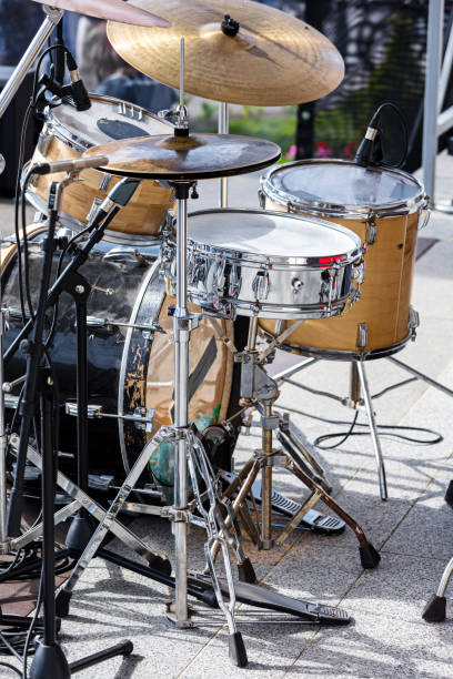 istock drum kit with microphones standing on outdoor stage 800364488