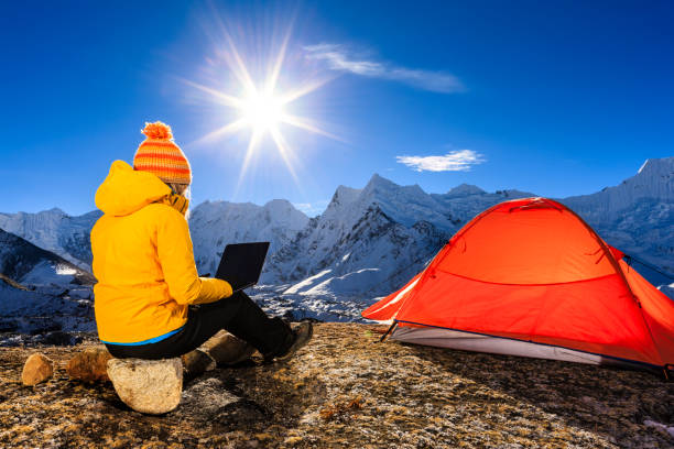 istock Young woman using laptop in Himalayas, Nepal 800364610