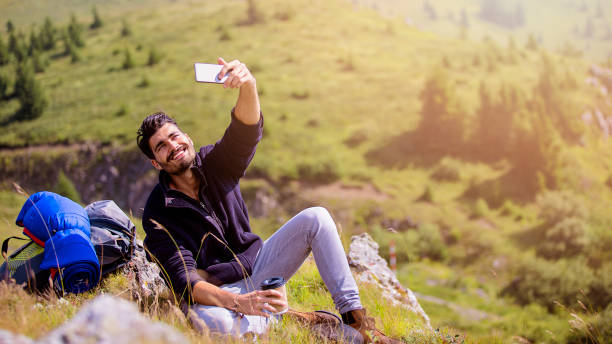 istock Smiling hiker in nature doing selfie 800368500