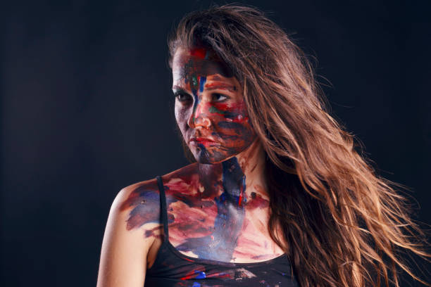 istock Girl with her face painted with her own hands. 800369216
