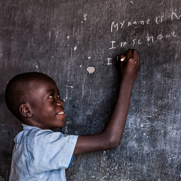 istock African young boy is learning English language, orphanage in Kenya 800372992