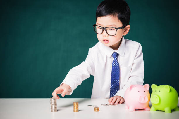 istock Cute business boy with a stack of coins 800375662