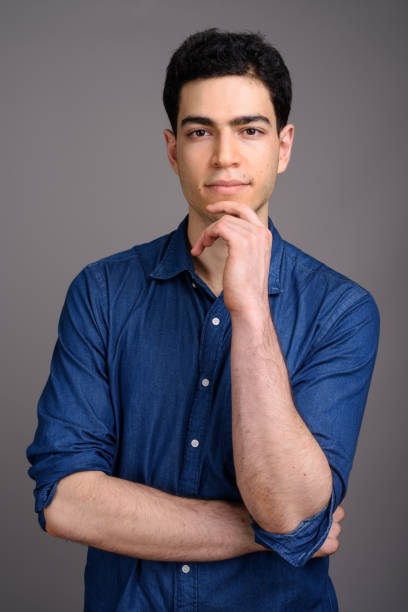 istock Studio shot of young handsome businessman against gray background 800378468