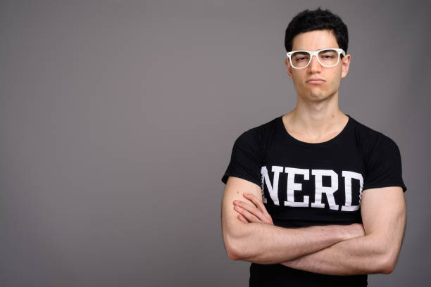 istock Studio shot of young handsome nerd man against gray background 800384022