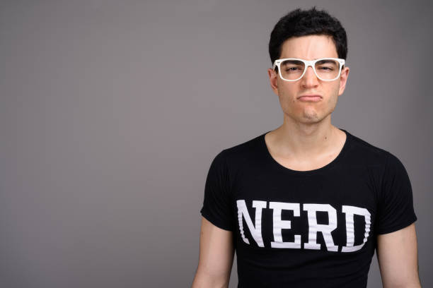 istock Studio shot of young handsome nerd man against gray background 800385442