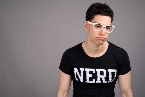 istock Studio shot of young handsome nerd man against gray background 800385776