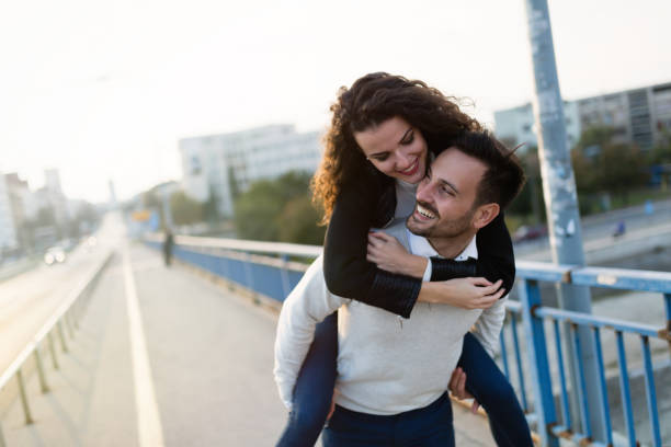 istock Handsome young man carrying on back his girlfriend 800387450