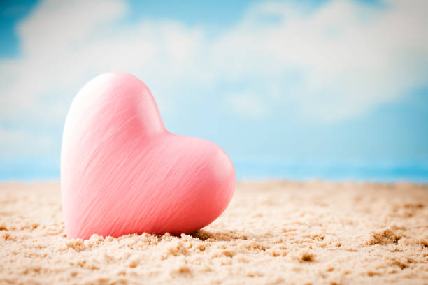 istock Heart on the sand on the seashore. 800389648