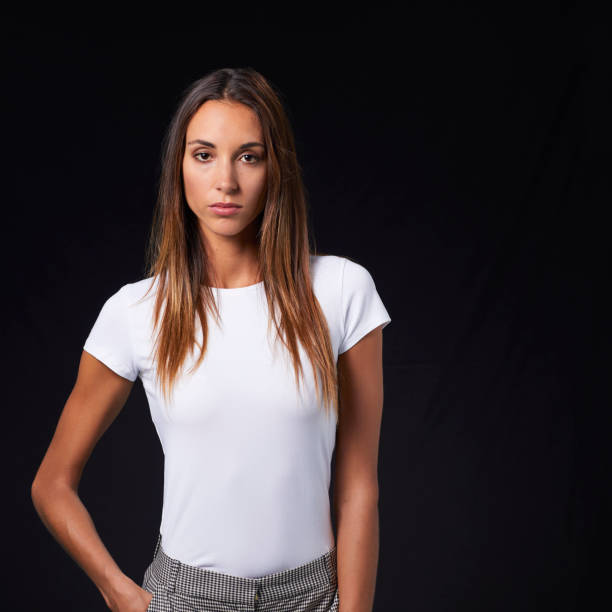 istock Young confident woman against black background 800395308