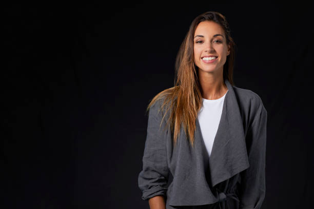 istock Smiling young woman in gray jacket 800395434