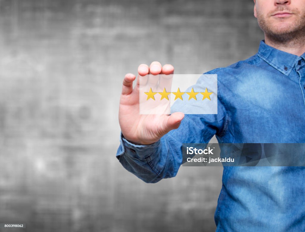 Man holding five star rating. Five stars service. Grey background - Stock Image Customer Stock Photo