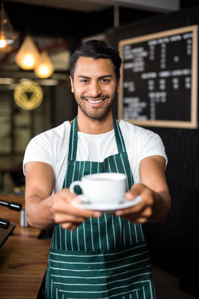 istock Smiling barista holding coffee 800398922
