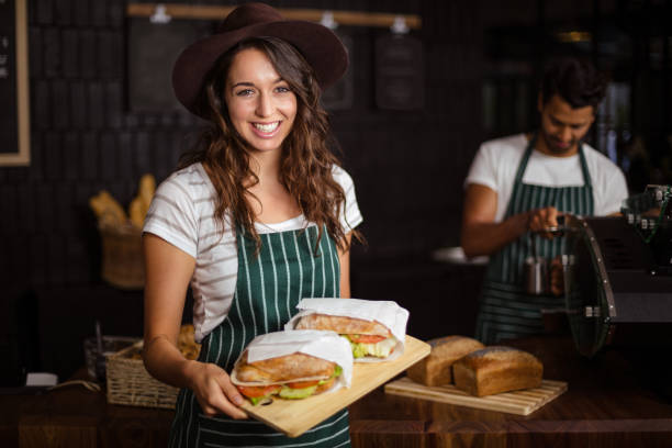 istock Smiling barista holding sandwiches 800402238