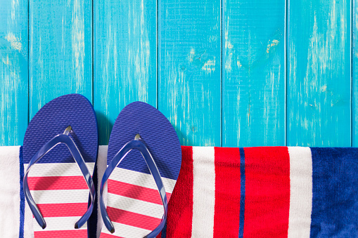 Flip flops with red white and blue pattern with July 4th theme.