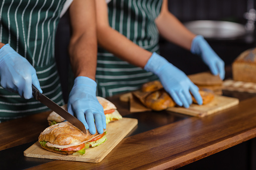 Close up of baristas preparing sandwiches in the bar