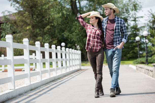 istock young cowboy with his girlfriend walking on pathway in park at daytime 800403082