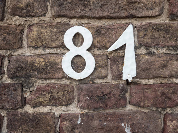 istock White house number 81 on an old brick wall 800406804
