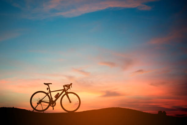istock Silhouette of a bike.bicycle on sunset background 800411084