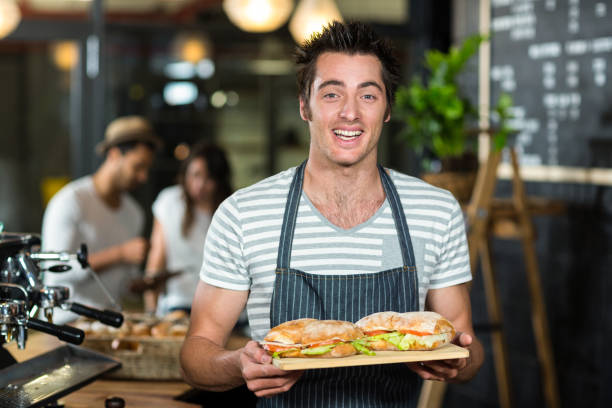 istock Smiling barista holding sandwiches 800413850