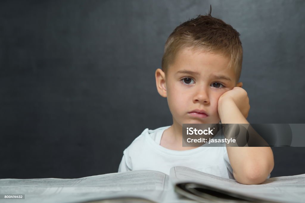 Little boy  like businessman in office with newspaper and cellphone Adult Stock Photo