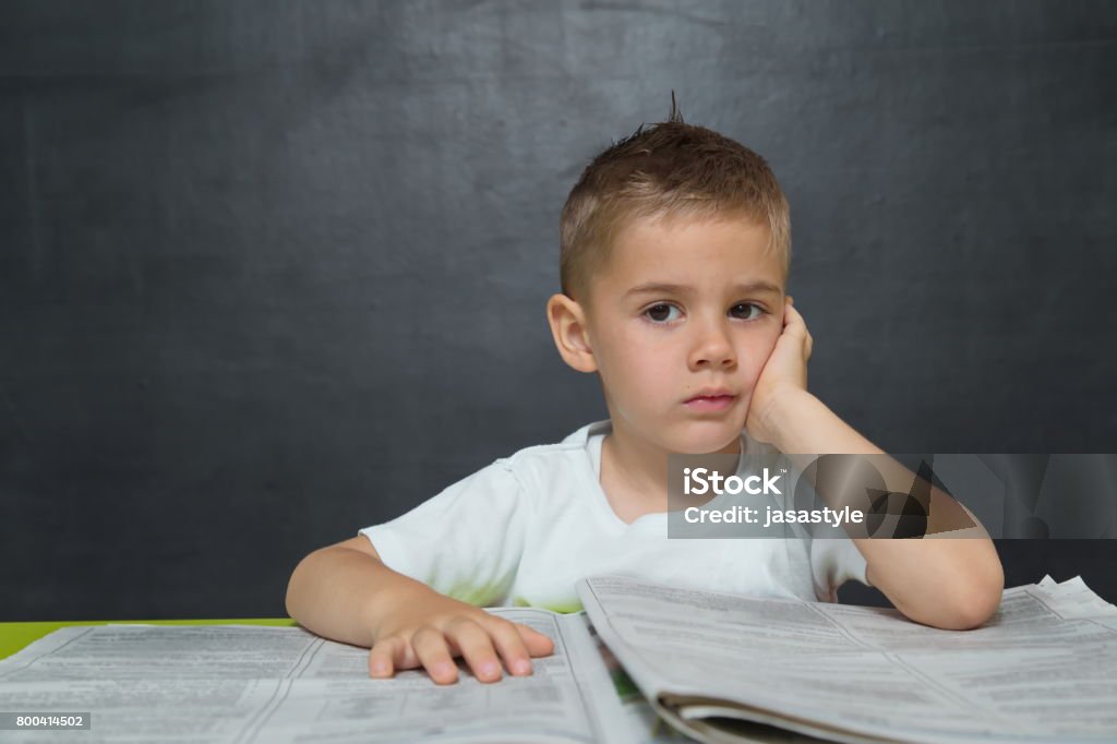 Little boy  like businessman in office with newspaper and cellphone Child Stock Photo