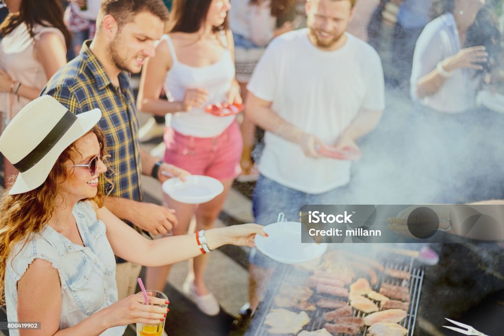 Group of friends having a good time at outdoor party Group of friends eating, drinking, dancing and having a good time at outdoor party Traditional Festival Stock Photo