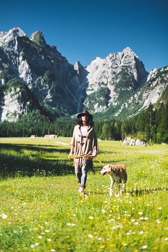 woman walking with the dog in the mountain