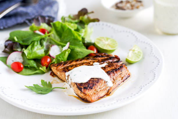 istock Glazed Salmon with salad by soured cream dressing 800441964