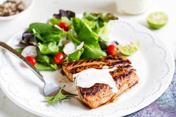istock Glazed Salmon with salad by soured cream dressing 800442672