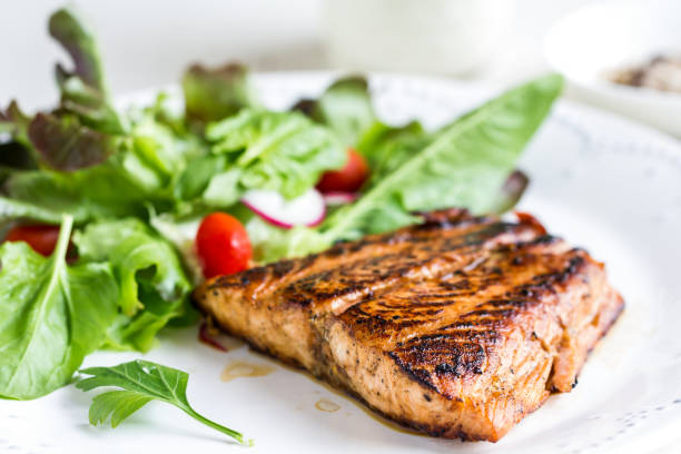 glazed salmon with salad by soured cream dressing - food dinner prepared fish gourmet imagens e fotografias de stock