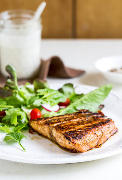 istock Glazed Salmon with salad by soured cream dressing 800444112