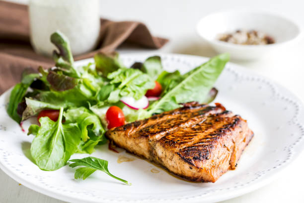 istock Glazed Salmon with salad by soured cream dressing 800444378