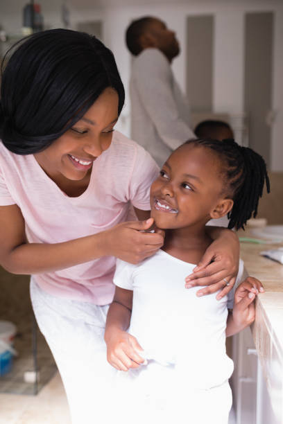 istock Mother checking daughters teeth in bathroom at home 800444542