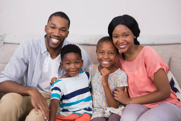 istock Happy family sitting on sofa at home 800445774