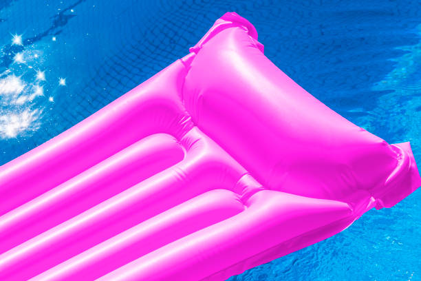 istock Green air mattress floating in a swimming pool. 800453650
