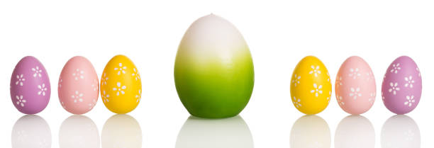 istock Row Easter eggs in center one big, isolated on white. 800468688