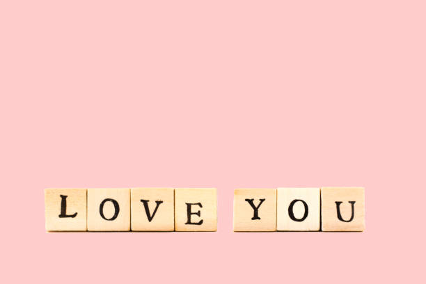 istock LOVE YOU: Written in Wood Block Letters, Pink Background 800475702